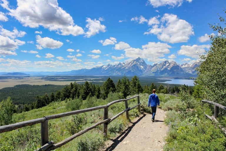 Boy hiking with lake and mountain view